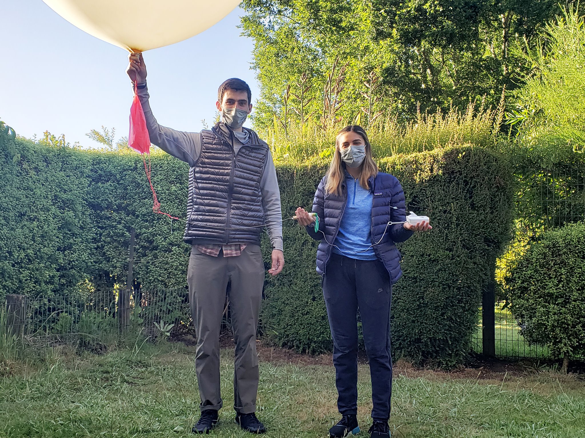 Two students in Chile, one holding a balloon and one holding a radiosonde