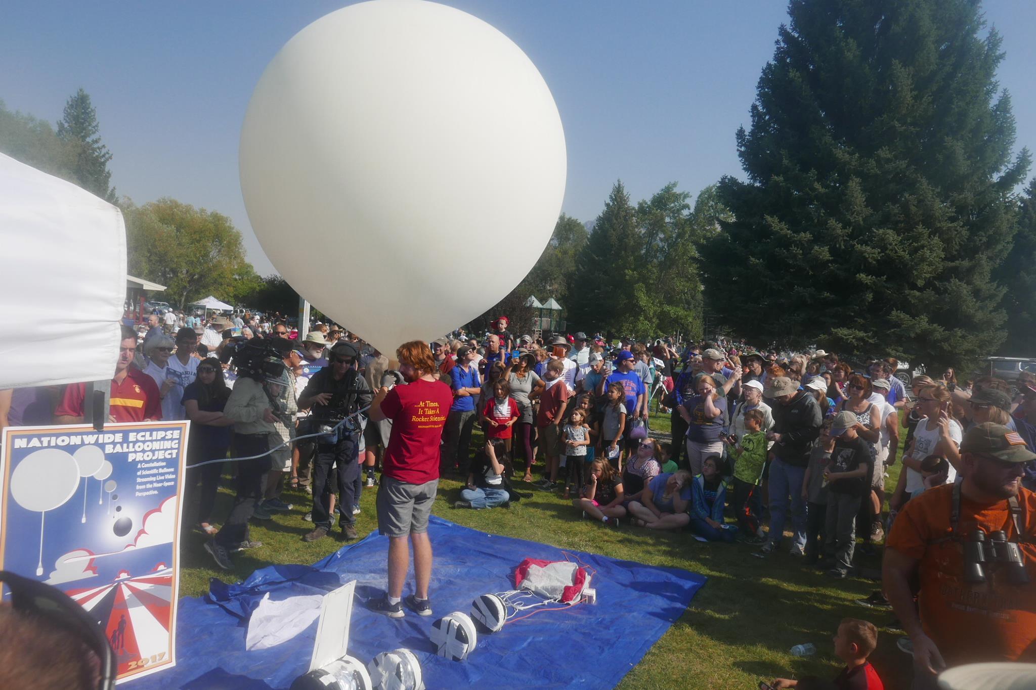 A large group gathered to watch the launch of a balloon