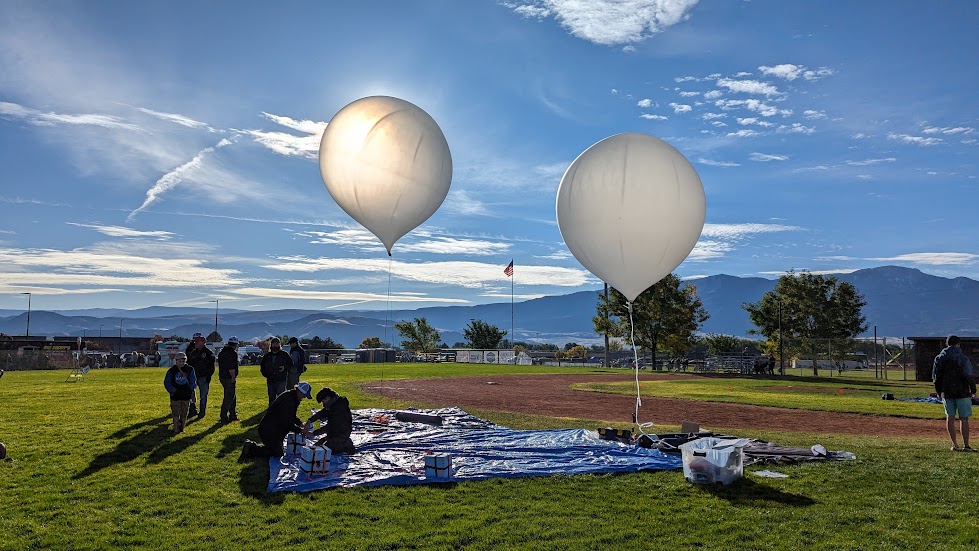 A team holding two balloons