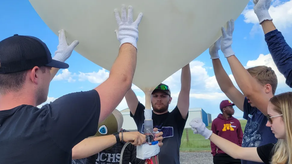 A team of people inflating balloons