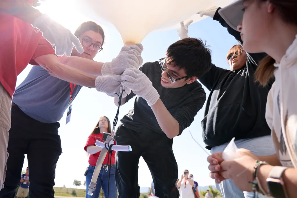 A team inflating a balloon