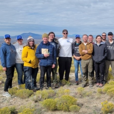 The borealis team standing in a field together