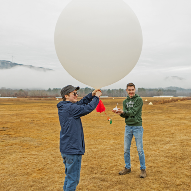 A team carrying a balloon