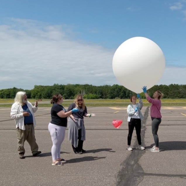 A team preparing a balloon
